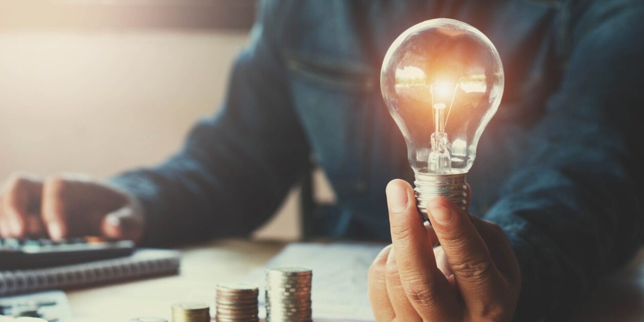 Lightbulb and money, hiring a patent attorney for a new invention concept