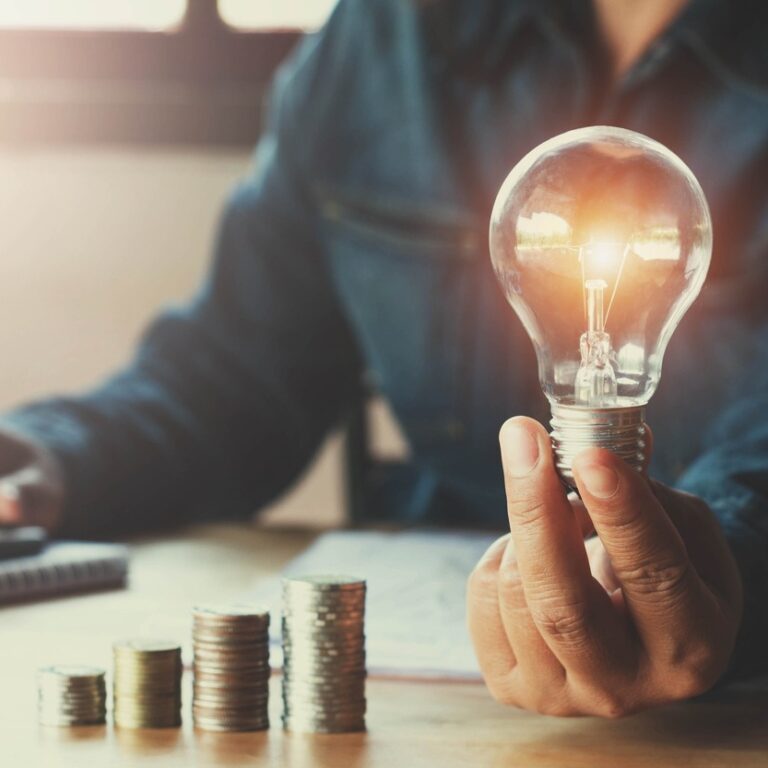 Lightbulb and money, hiring a patent attorney for a new invention concept