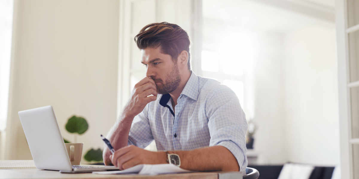 Man at computer reviewing rejected patent application