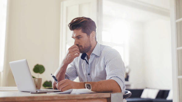 Man at computer reviewing rejected patent application