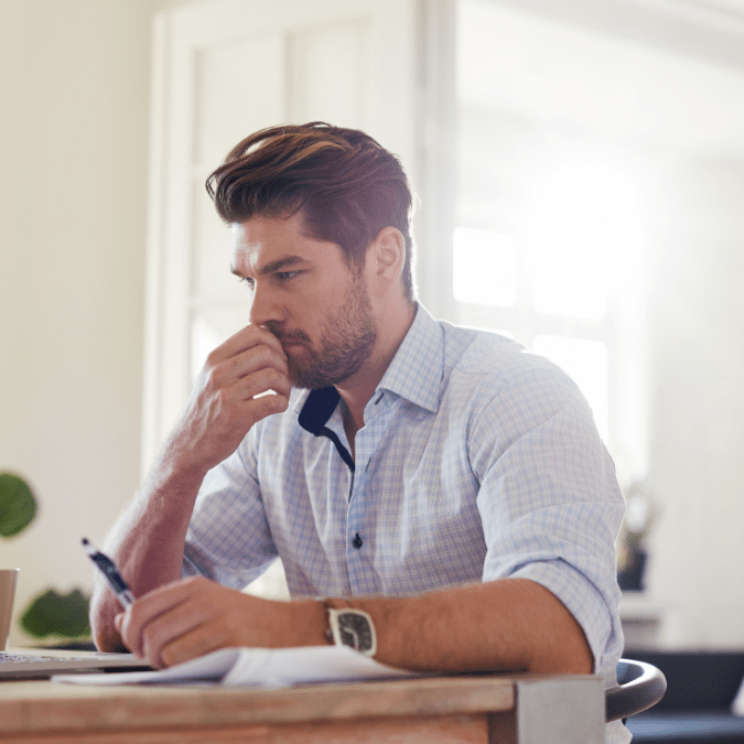 Man at computer reviewing rejected patent application