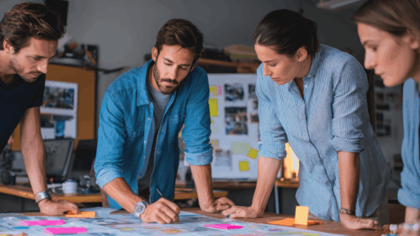 A team around a desk at a startup company planning their IP strategy