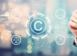 Person reviewing creative work with digital copyright symbol