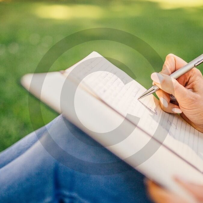 Writer working on a novel with copyright symbol overlay