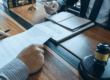 An attorney and client sitting at a desk discussing patent infringement case