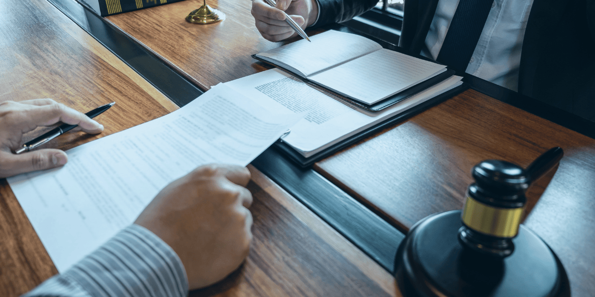 Questions to ask your patent attorney An attorney and client sitting at a desk discussing patent infringement case