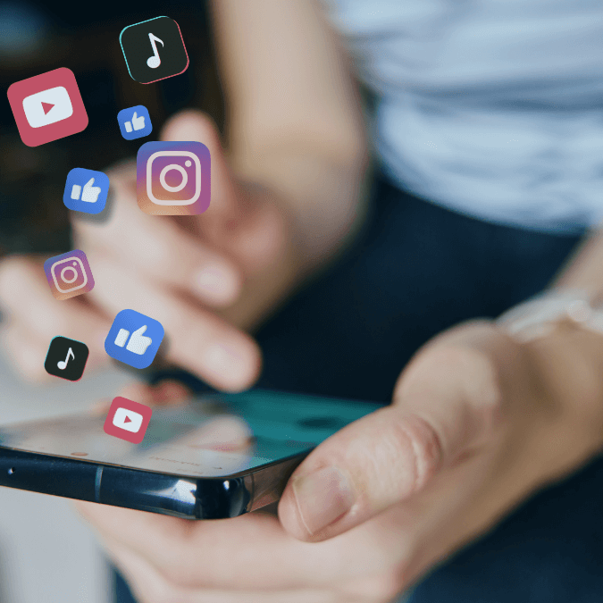 Person using a smartphone with social media app icons floating above, representing online sharing and copyright considerations for businesses.