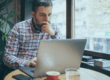 Business owner looking at an online trademark application and deciding if he needs the help of a lawyer.