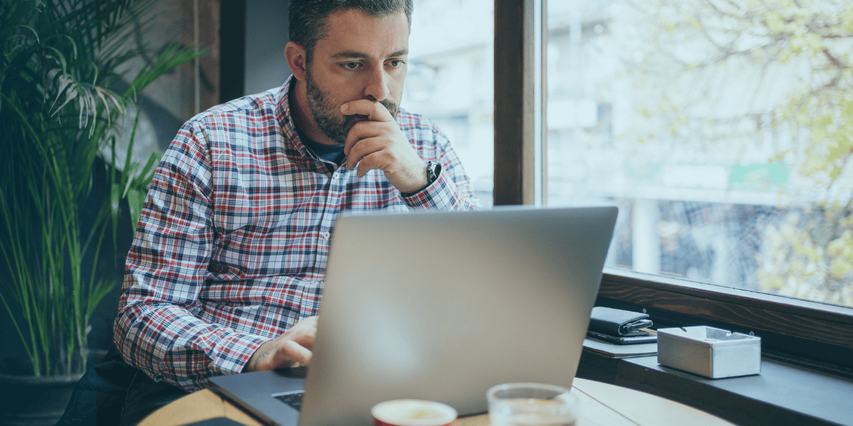 Business owner looking at an online trademark application and deciding if he needs the help of a lawyer.
