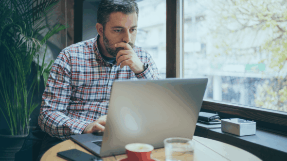 Business owner looking at an online trademark application and deciding if he needs the help of a lawyer.