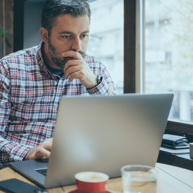 Business owner looking at an online trademark application and deciding if he needs the help of a lawyer.