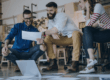 Three inventors reviewing documents while preparing a patent application