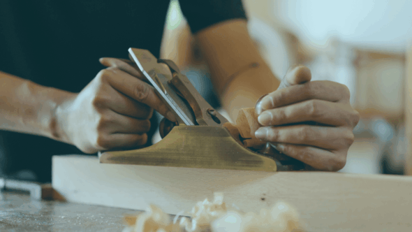 Person woodworking with tools