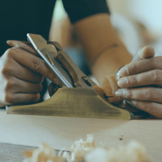 Person woodworking with tools