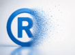 Trademark symbol dissolving to represent the risk of losing legal protection